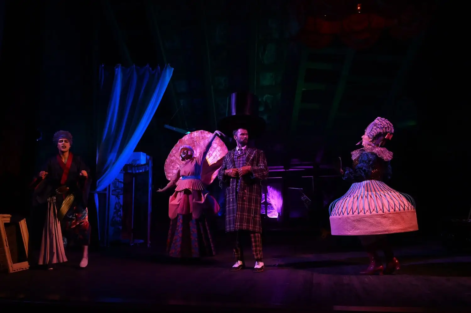 Costumed actors performing together on a theatre stage