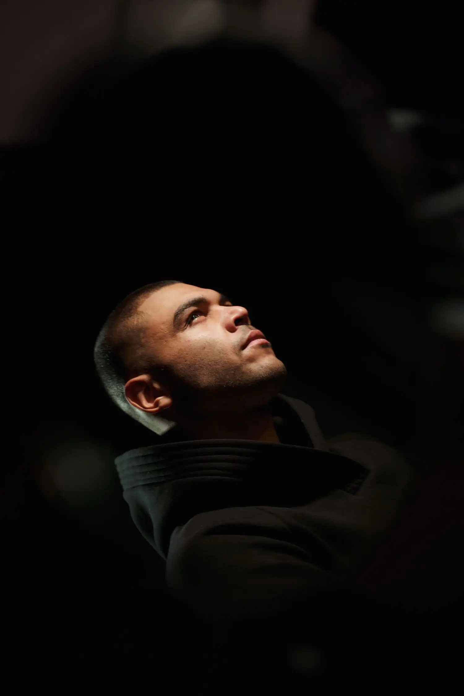 Actor resting between rehearsal exercises in a dark theatre