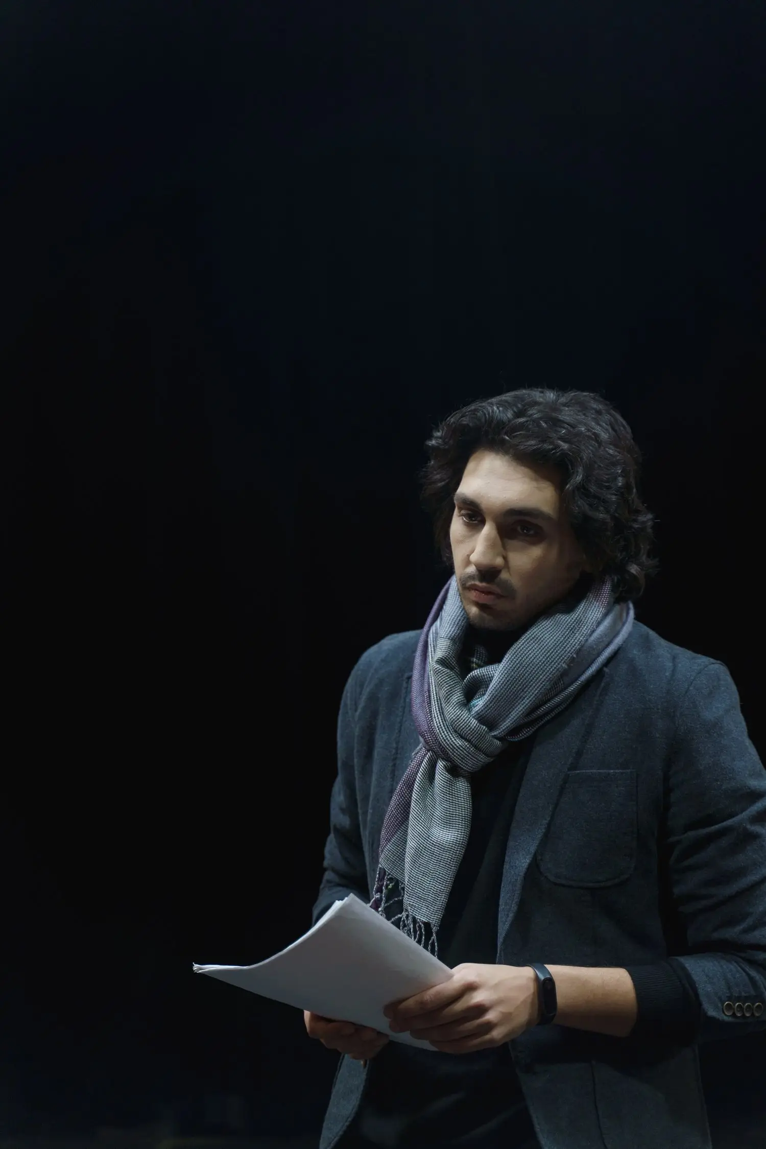 Actor holding a script during rehearsal