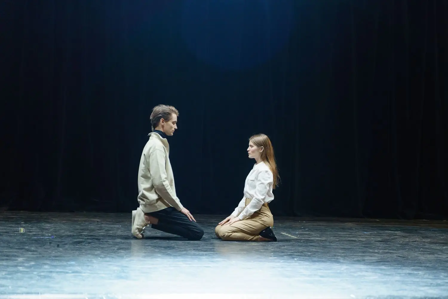Two performers rehearsing a scene on stage