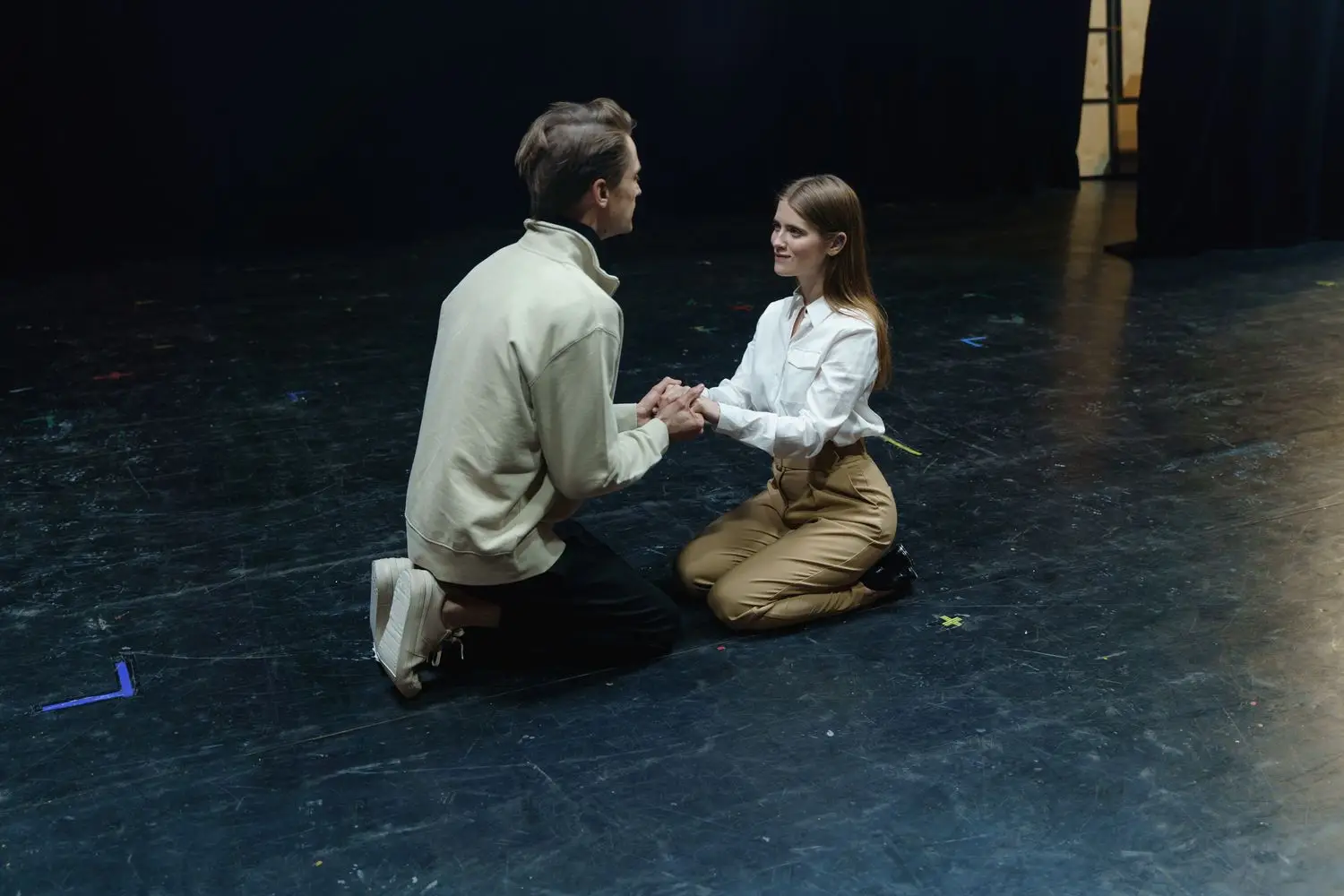 Two actors rehearsing a close scene on stage