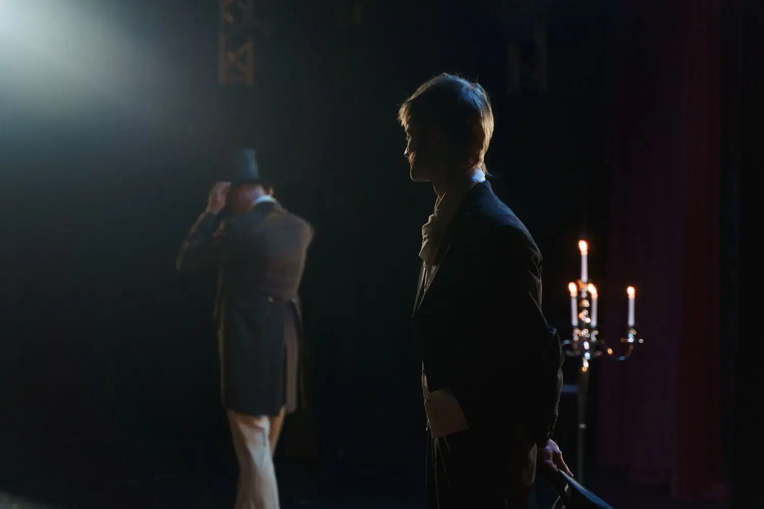 Two actors in a dramatic stage scene
