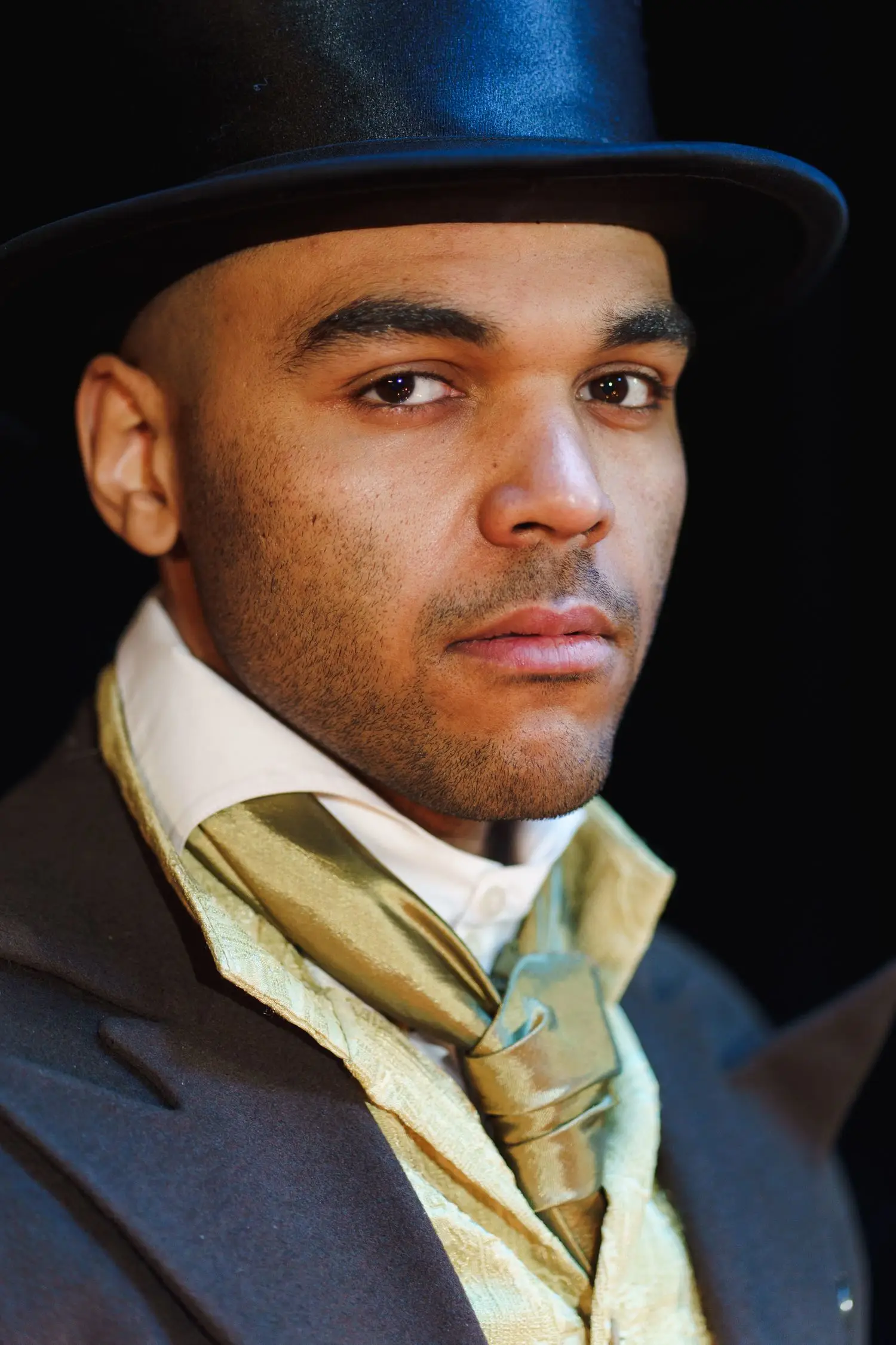 Costumed actor portrait under theatre lighting