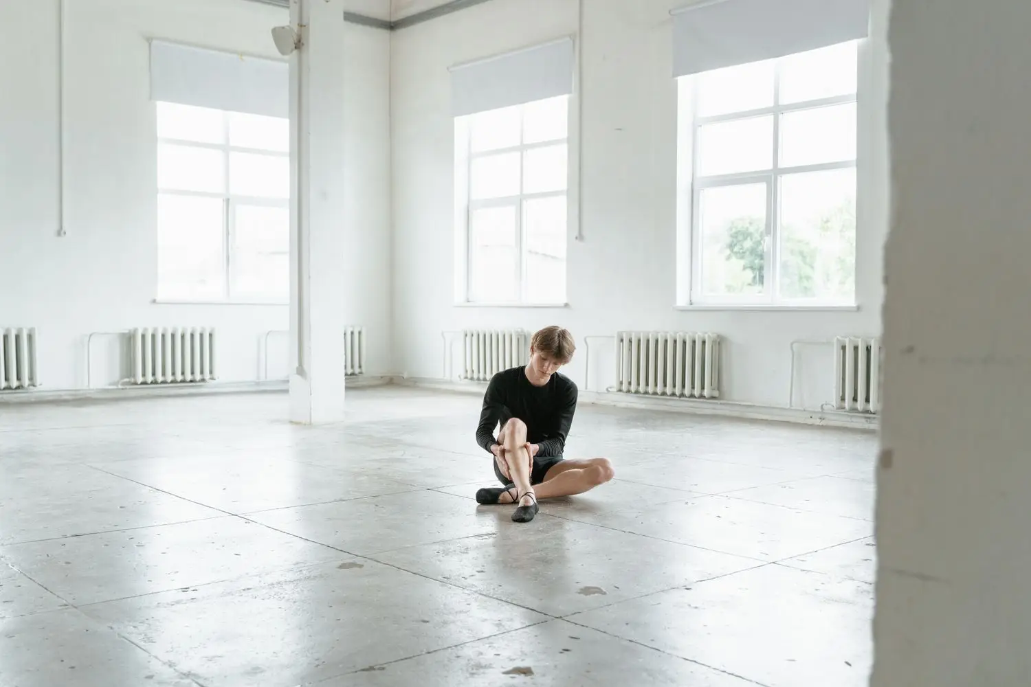 Performer sitting in a bright rehearsal studio
